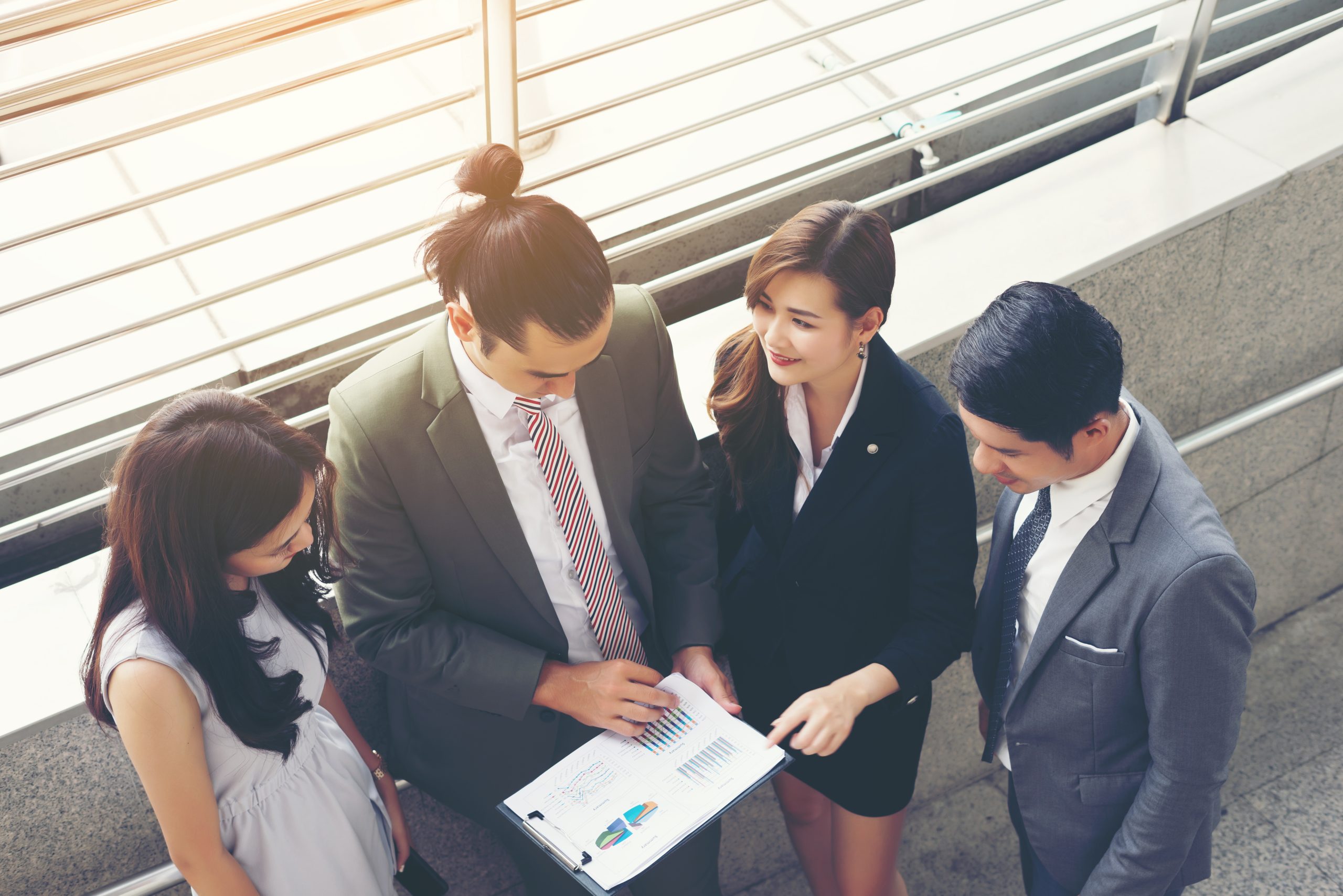Business teamwork with document in her hands, watching some interesting content during lunch break
