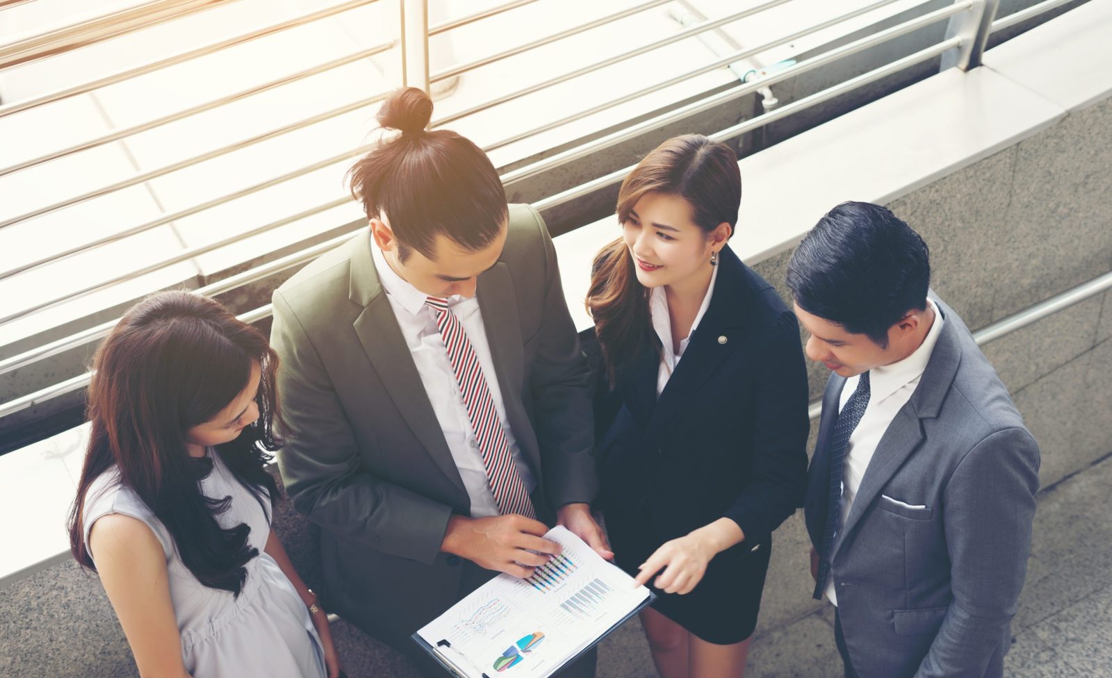 Business teamwork with document in her hands, watching some interesting content during lunch break